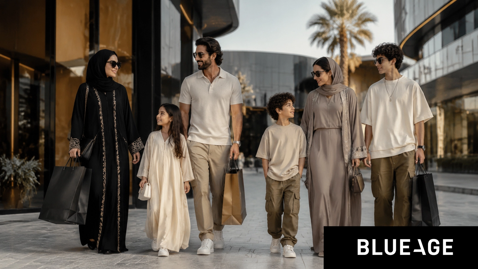 Stylish Saudi family shopping in a modern luxury mall wearing trendy Blue Age بلو إيج fashion including abayas, modest dresses, polo shirts, and casual streetwear outfits.